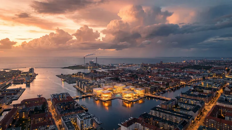 Glowing pavilions on the water of a harbor city at dusk